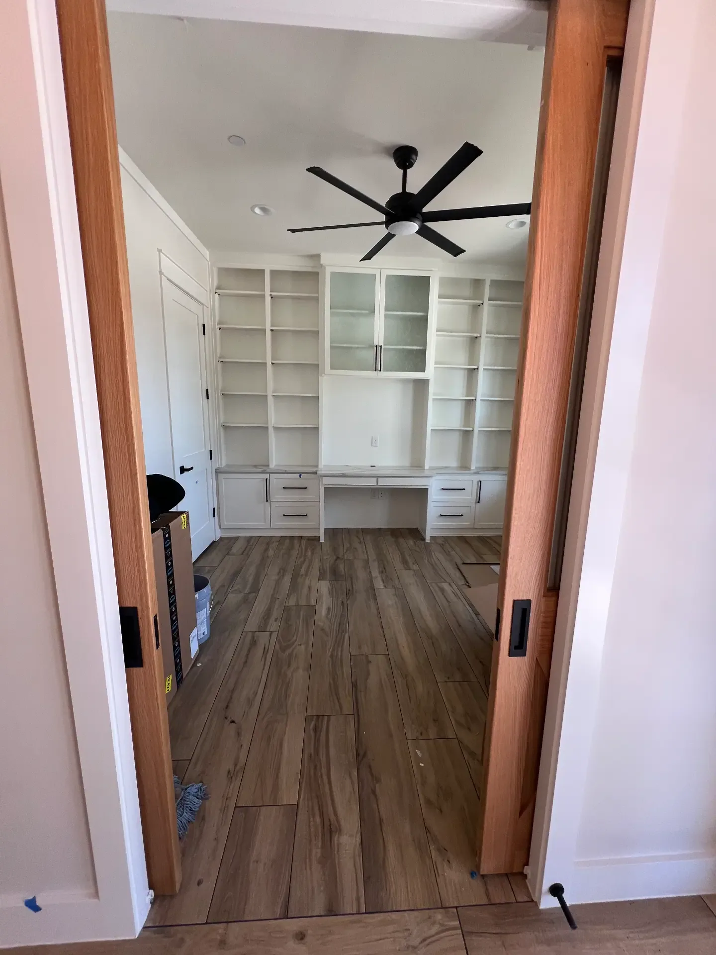 Home office with custom white built-in cabinetry in a Venado Construction new home build