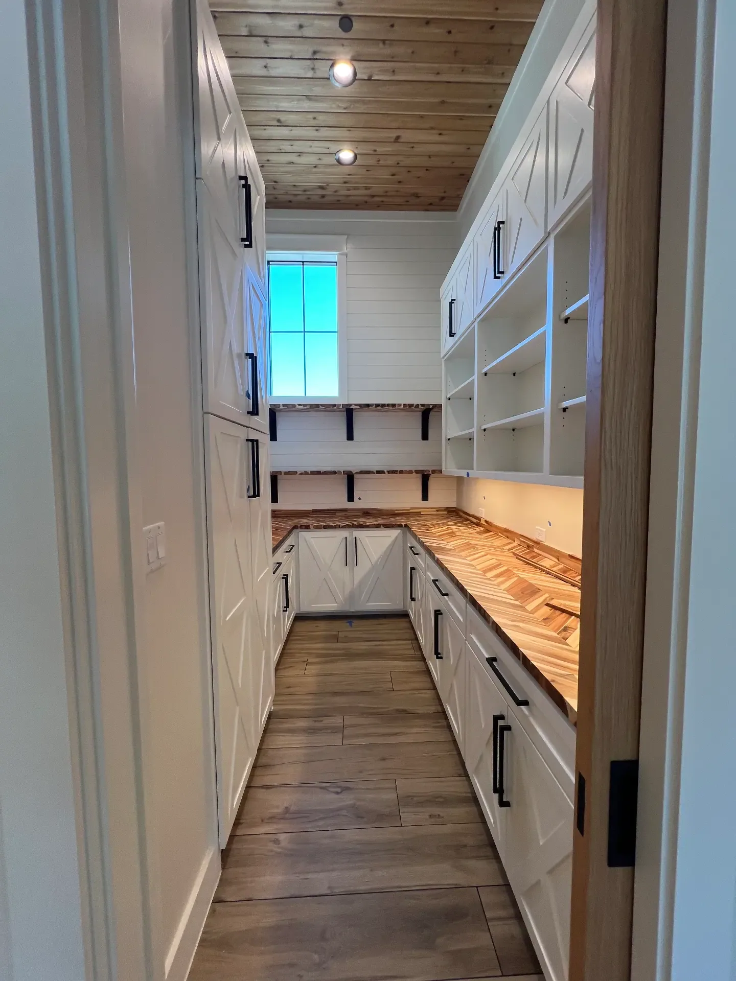Walk-in pantry with custom shelving in a Venado Construction new home build