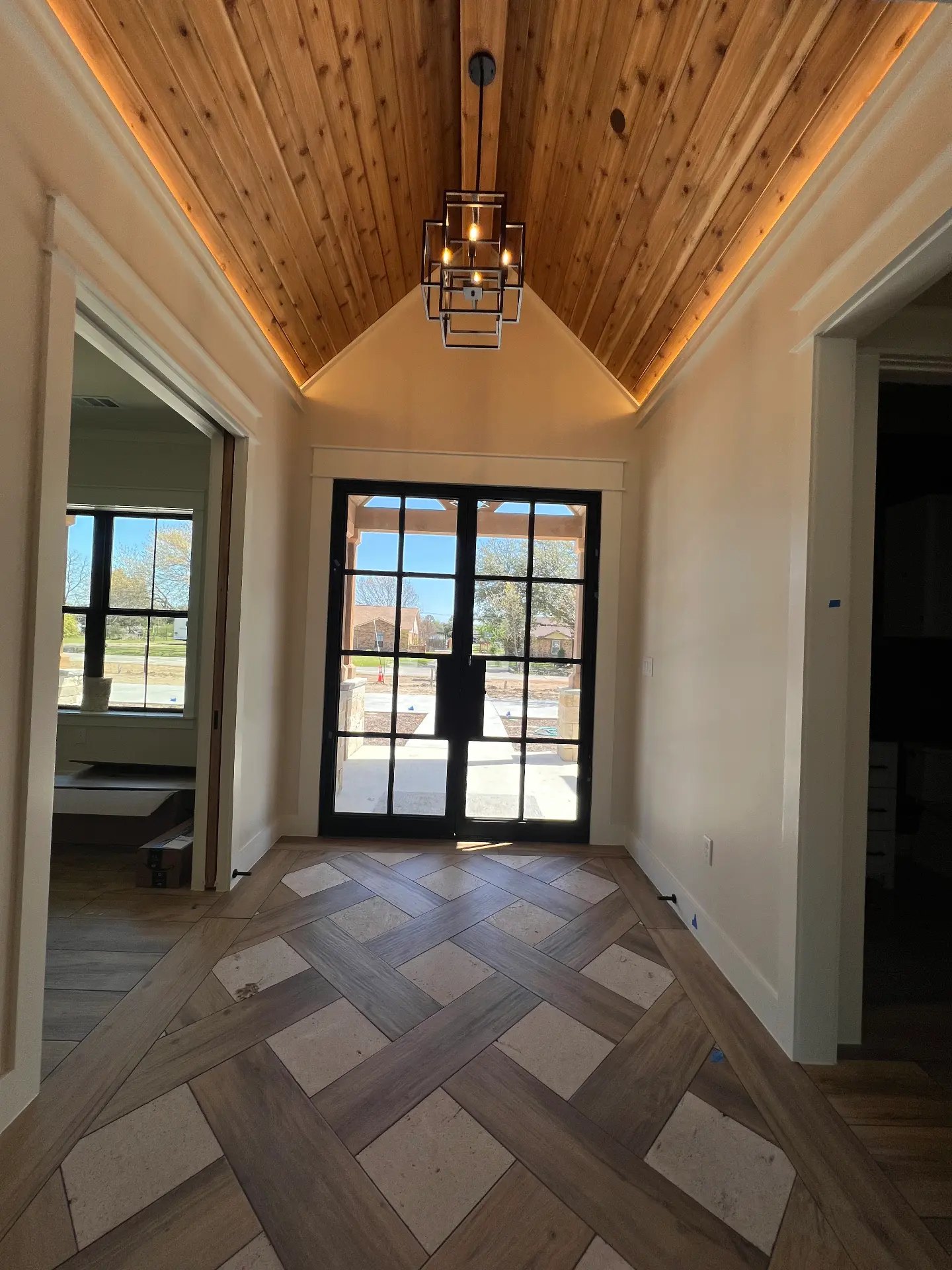 Vaulted stained tongue-and-groove entry ceiling in a new home built by Venado Construction